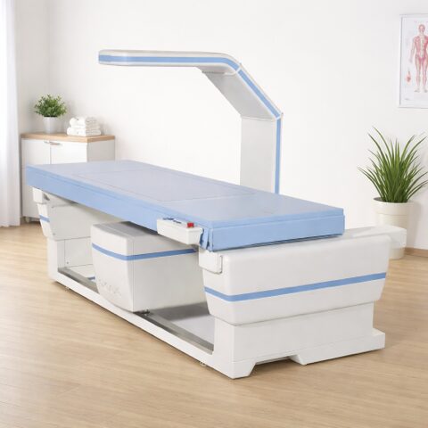 Modern medical examination table with adjustable overhead light in a clean clinic room.